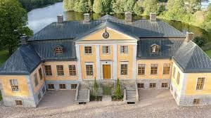 Aerial view of Hörle Herrgård — the yellow 1746 manor beside the Lagan River in Småland.